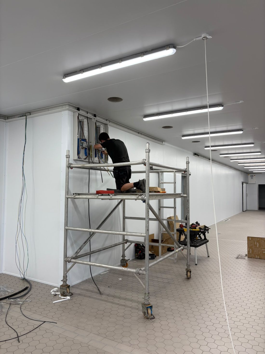 Fitting new lighting from a scaffold tower in a commercial unit